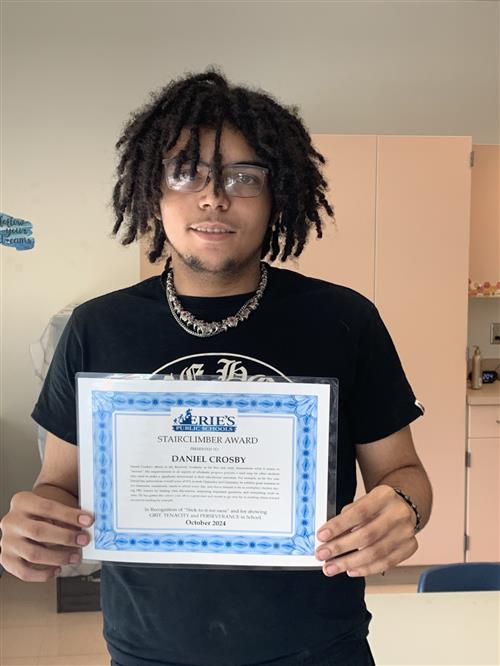 Daniel Crosby, Patrick J. DiPaolo's Stairclimber for October, poses with his certificate. 